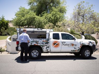 Naturzone Service Professional standing next to his truck
